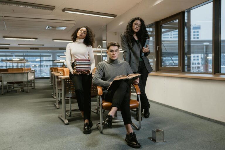 Multiracial college students studying in a library setting. Engaged learning environment.